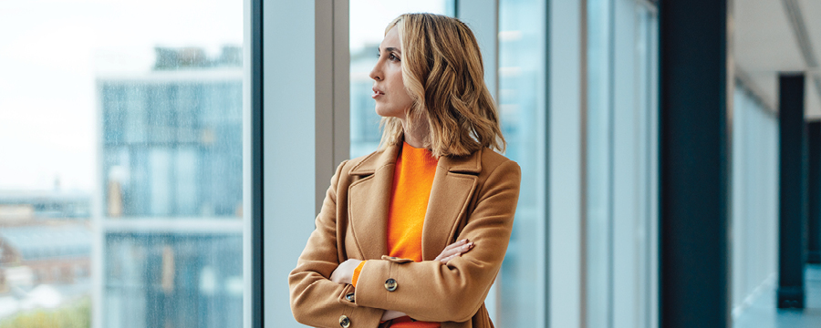 Businesswoman looking out window.